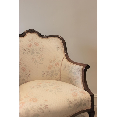 619 - An Edwardian mahogany framed tub chair, the floral pattern top above a serpentine seat raised on cab... 