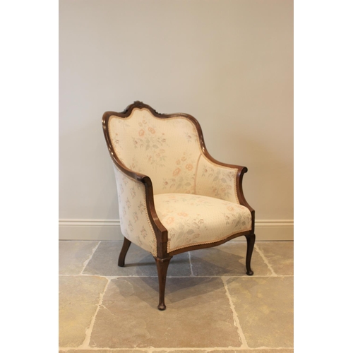 619 - An Edwardian mahogany framed tub chair, the floral pattern top above a serpentine seat raised on cab... 