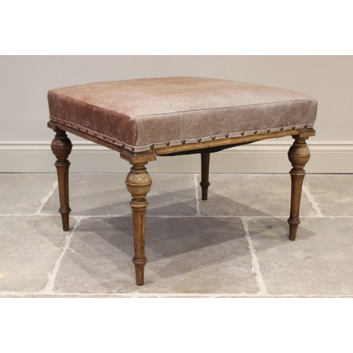 622 - An early 20th century French walnut and leather dressing stool, the tan leather padded seat raised u... 