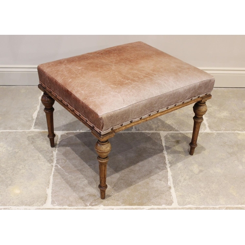 622 - An early 20th century French walnut and leather dressing stool, the tan leather padded seat raised u... 