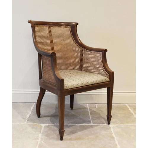 626 - An Edwardian mahogany bergere tub chair, on fore legs of tapering square section, 90cm high