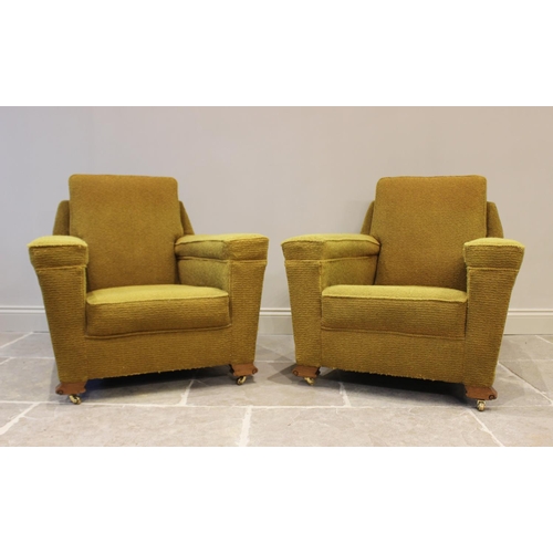 631 - A pair of Art Deco yellow upholstered armchairs, each with an angular padded back above a deep set s... 