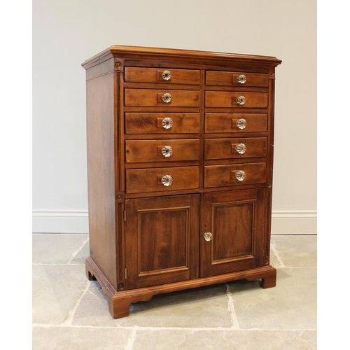 637 - An early 20th century walnut specimen cabinet, the rectangular moulded top above an arrangement of t... 