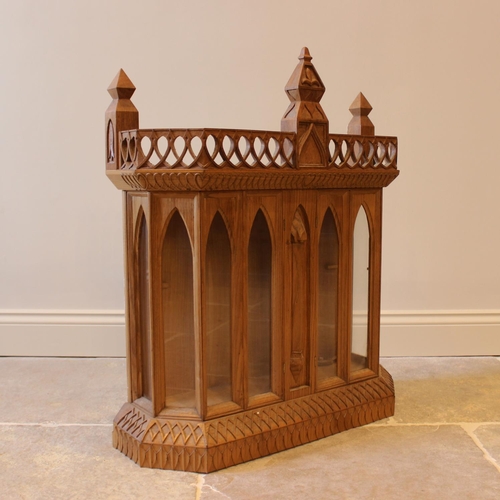 639 - A carved oak Gothic revival wall hanging display cabinet and bracket, 20th century, with six arched ... 