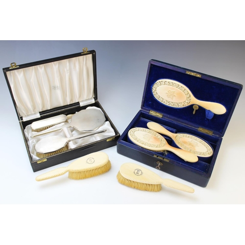 64 - A cased set of carved ivory brushes and a mirror, each piece with intricately carved frieze of roses... 