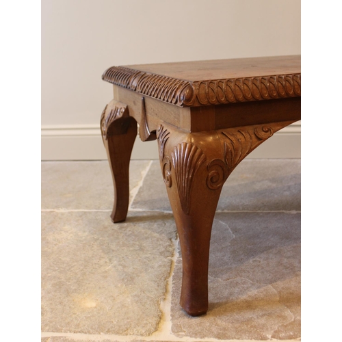 642 - A 20th century teak Queen Anne style rectangular coffee table, with shell and foliate carved detail,... 