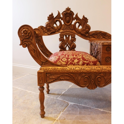 645 - A carved oak telephone table, 20th century, the carved back with mythological creatures, the upholst... 