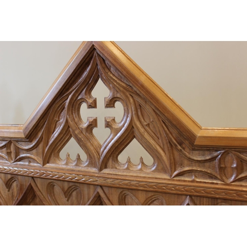 646 - A carved oak Gothic revival headboard, 20th century, 151cm wide, along with a matched bedside table ... 