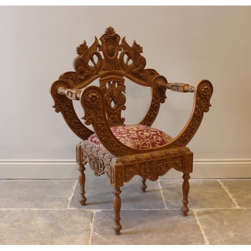 647 - A carved oak chair, 20th century, the carved back with mythological creatures, above an upholstered ... 