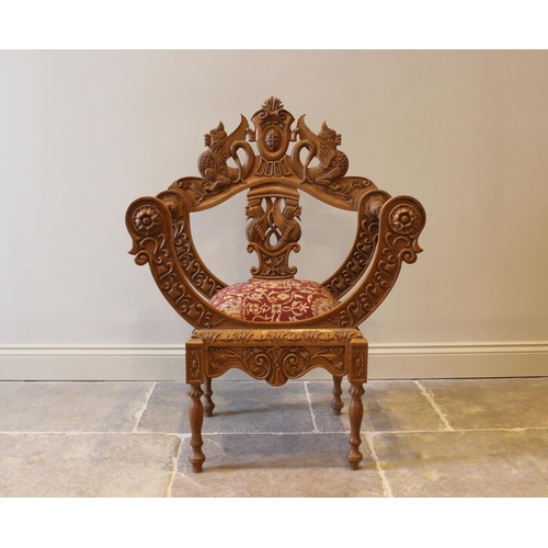 647 - A carved oak chair, 20th century, the carved back with mythological creatures, above an upholstered ... 