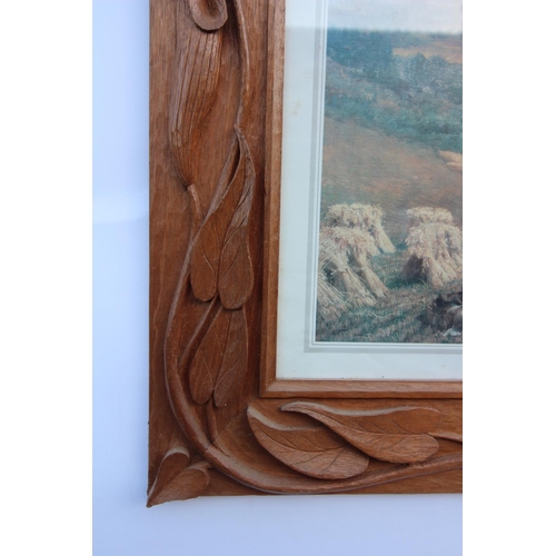 649 - A carved oak gothic revival glazed frame, 20th century, of twin turret form with central pine cone m... 