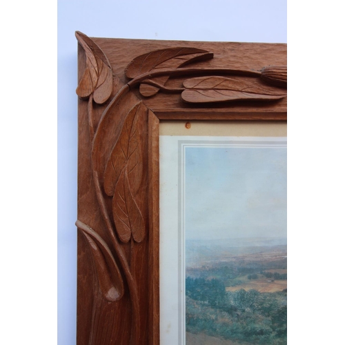 649 - A carved oak gothic revival glazed frame, 20th century, of twin turret form with central pine cone m... 