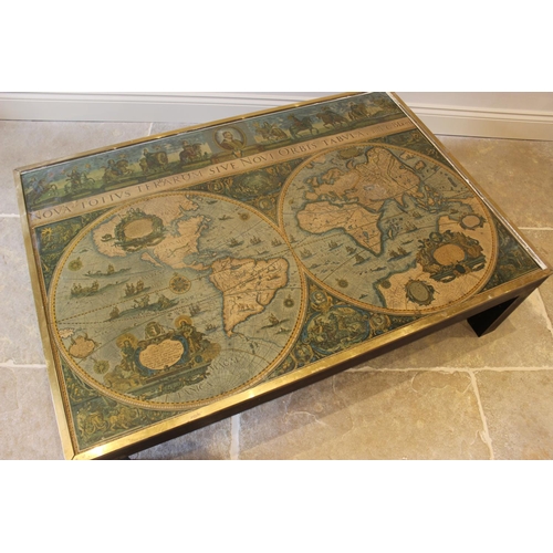 650 - A campaign style rectangular coffee table, with glazed top inset with a map and raised on four stile... 