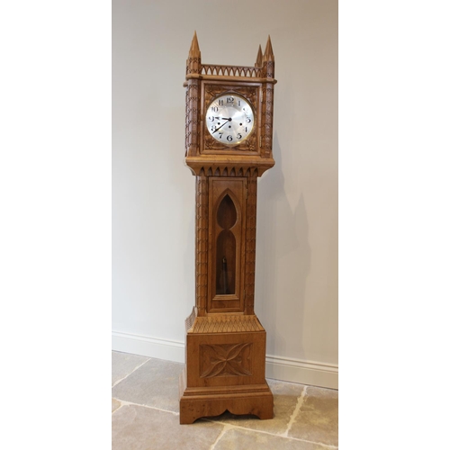 651 - An ecclesiastical carved oak grandmother clock, 20th century, the hood inspired by Lichfield Cathedr... 