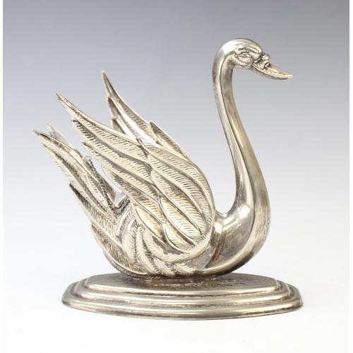 87 - A white metal brandy warmer in the form of a swan, on stepped base with central burner and extinguis... 