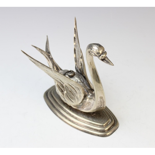 87 - A white metal brandy warmer in the form of a swan, on stepped base with central burner and extinguis... 