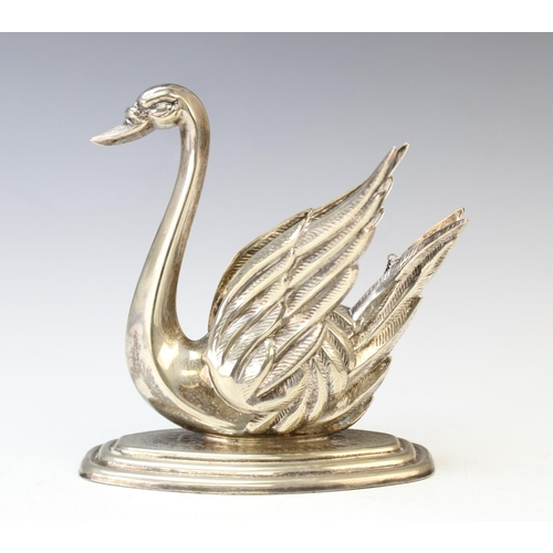 87 - A white metal brandy warmer in the form of a swan, on stepped base with central burner and extinguis... 