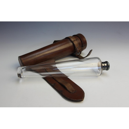 95 - A clear glass hunting flask in leather case, early 20th century, the conical flask with white metal,... 