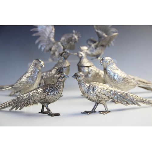 112 - A collection of nickel-plated decorative table centrepieces, 20th century, modelled as a pair of fig... 