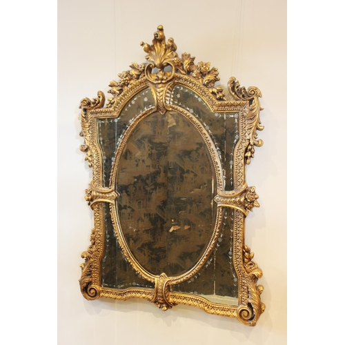 556 - A Louis XVI style giltwood and composition wall mirror, 20th century, the rococo leaf scroll frame e... 