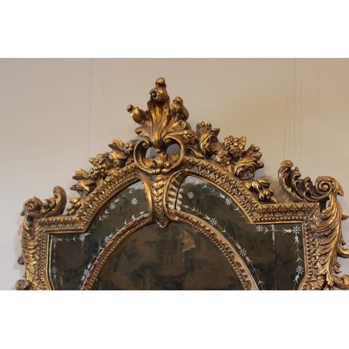 556 - A Louis XVI style giltwood and composition wall mirror, 20th century, the rococo leaf scroll frame e... 