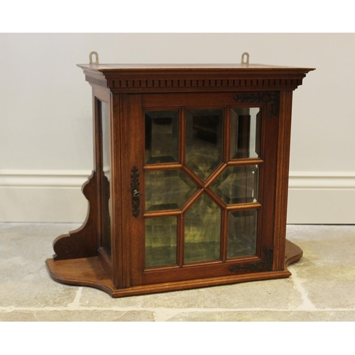 565 - A late Victorian glazed walnut wall cabinet, with a dentil cornice above an astral bevel glazed sing... 