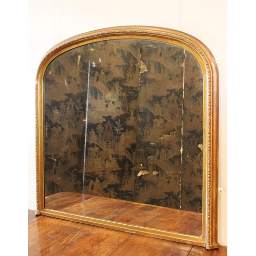 605 - A Victorian giltwood and gesso over-mantel mirror, of typical arched form, the frame applied with a ... 