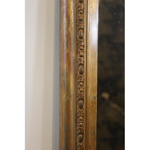 605 - A Victorian giltwood and gesso over-mantel mirror, of typical arched form, the frame applied with a ... 