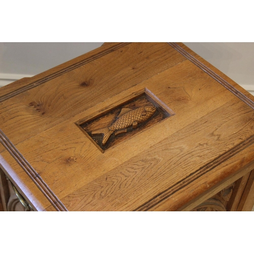 644 - A carved oak box with hinged cover, 20th century, in Gothic revival style and upon four paw feet, 52... 