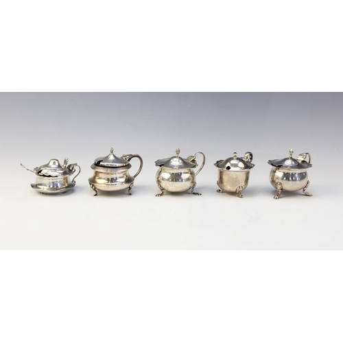 16 - A selection of silver mustard pots and salts to include; a pair of open salts by James Swann, Birmin... 