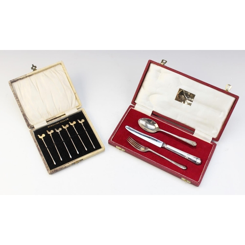 91 - A cased set of six silver sandwich skewers, each surmounted with a realistically modelled gilt cocke... 