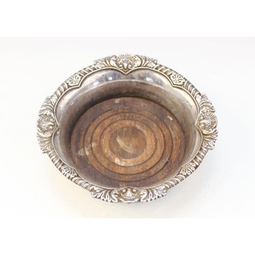 99 - A silver mounted bottle coaster by C J Vander Ltd, Sheffield 1988, of circular form with shell and g... 