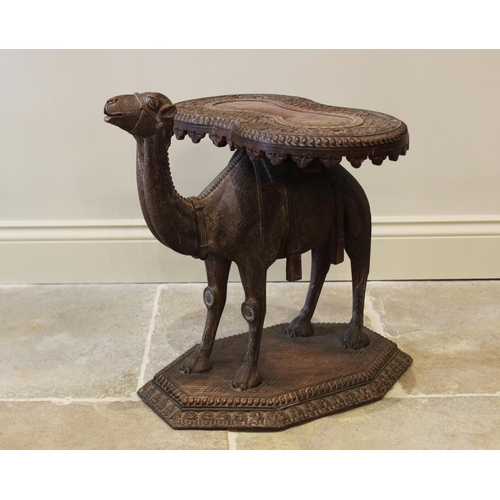 579 - An Anglo-Indian camel form occasional table, 19th century, the kidney shaped table top carved with a... 