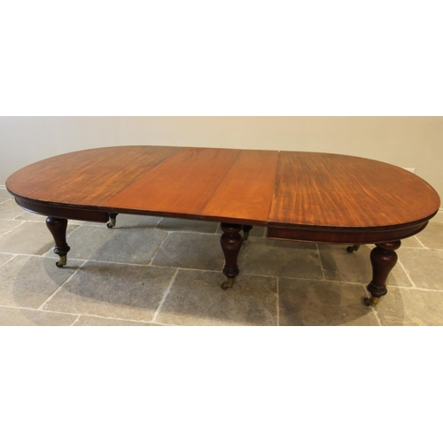 588 - A mid 19th century mahogany extending dining table, the oval top above a plain frieze raised upon si... 