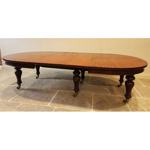 588 - A mid 19th century mahogany extending dining table, the oval top above a plain frieze raised upon si... 