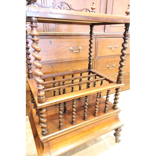 613 - An early Victorian rosewood etagere Canterbury, the four turned finials above a fretwork three quart... 