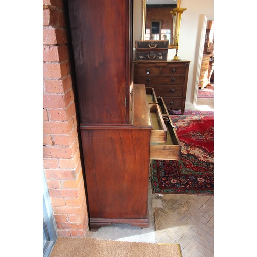 599 - A mid 19th century mahogany linen press, the moulded cornice above a pair of invert moulded cupboard... 