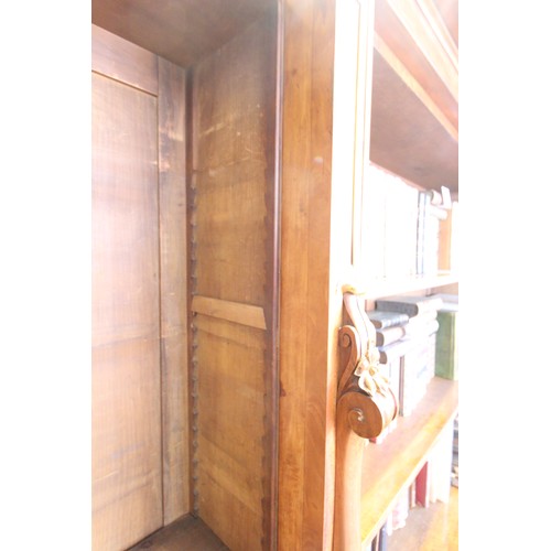 562 - A mid 19th century satin birch breakfront open bookcase, the moulded cornice above the central secti... 