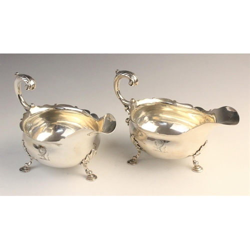 104 - A pair of George II silver sauce boats by William Grundy, London 1755, each of classic form with sha... 