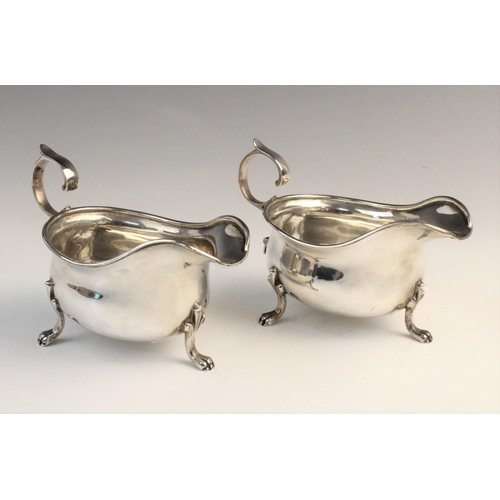 107 - A pair of George V silver sauceboats by M Beaver Ltd, Sheffield 1936, each of typical form with scro... 