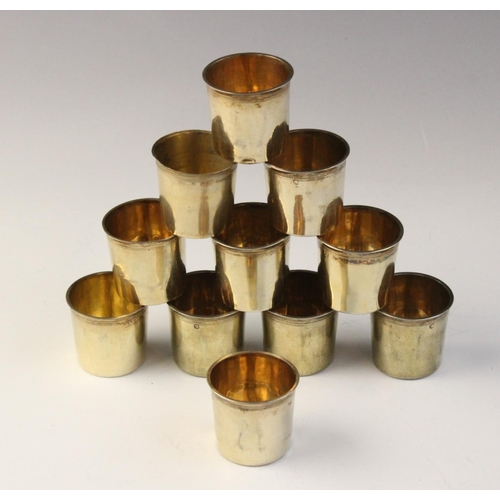 108 - A set of ten early 19th century French silver gilt tots, each of plain polished cylindrical form wit... 