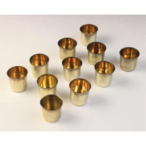 108 - A set of ten early 19th century French silver gilt tots, each of plain polished cylindrical form wit... 