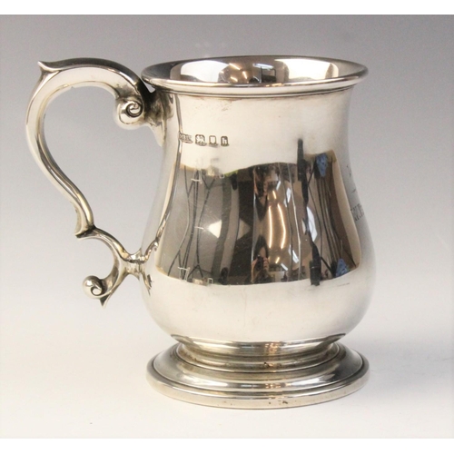 109 - A George V silver bell-shaped mug, marked for ‘MB Ltd’ London 1923, plain polished on stepped circul... 