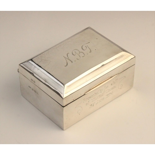 111 - A George V silver cigarette box by F H Adams & Co, Birmingham 1922, of rectangular form with engine ... 