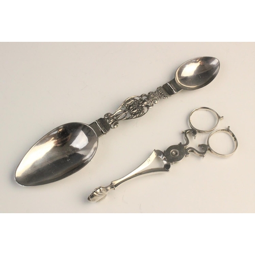 126 - A pair of eighteenth century silver sugar nips, circa 1750, 12.6cm long, together with a folding dou... 