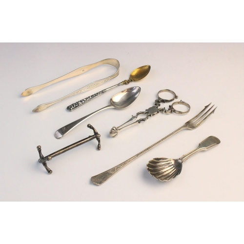 44 - An assortment of silver cutlery, to include; a pair of George III silver sugar tongs, with shell for... 
