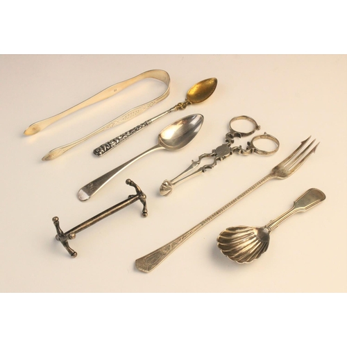 44 - An assortment of silver cutlery, to include; a pair of George III silver sugar tongs, with shell for... 
