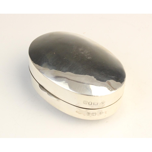 49 - A Victorian silver pill box by William Hutton & Sons, London 1899, of convex oval form, the hinged c... 