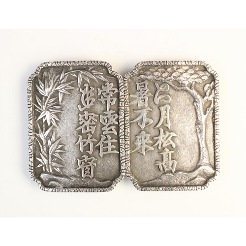 59 - A Chinese export silver belt buckle, comprising two rectangular panels with canted corners, embossed... 
