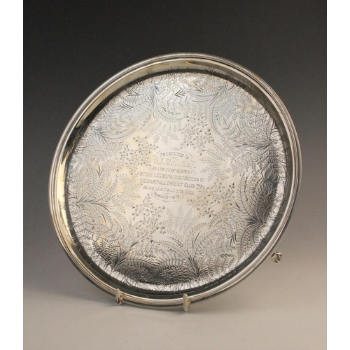 69 - A Victorian silver salver by James Dixon & Sons, Sheffield 1877, of circular form on three paw feet,... 